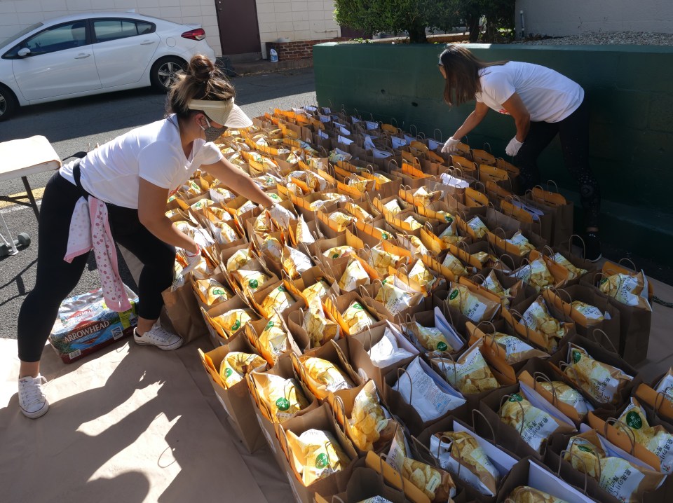 From left to right: Denise Yamaguchi and Aya Leslie, volunteer to pack PPE gear into bags to be picked up by local restaurants registered on Food-To-Go-Go, on Monday, June 1, 2020, in Honolulu, HI. The PPE gear was donated by the Maui-based farming company Mahi Pono with the help of the Hawaii Agriculture Foundation (HAF) in a joint effort to offset hard hit restaurant businesses island-wide as they prepare to reopen dine-in services on June 5th. (Ronen Zilberman photo Civil Beat)