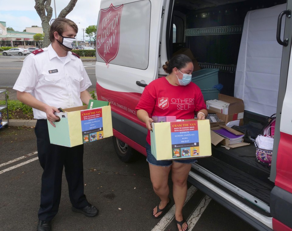 Lt. Aaron Ruff, Core Officer (left) and Marissa Fierro, Volunteer Coordinator (right) both of the Salvation Army, load boxes of donations into their vehicle during their "Cram the Van" Back-to-School-Drive at the Windward Mall in Kaneohe, Saturday, July 18, 2020. This marks the second year in a row that the Windward Mall has partnered with the Salvation Army to help procure school supplies for the windward community. (Ronen Zilberman photo Civil Beat)