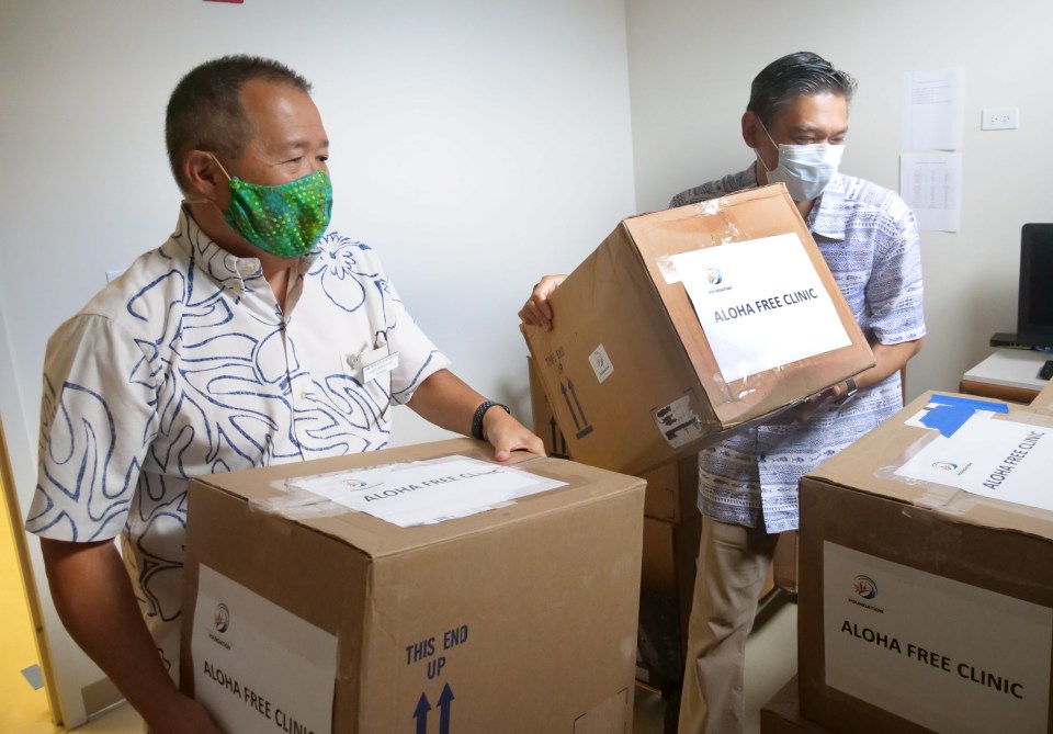 Gary Yonemoto, president of the Hawaii Dental Association Foundation and Dr. Jeffrey Sonson unload oral health kits for the for the Aloha Free Hawai'i Clinic on Thursday, July 2, 2020. The 2,500 kits provided by the Hawaii Dental Association Foundation include toothpaste, toothbrushes, floss, and educational materials. (Photo: Ronen Zilberman/Civil Beat)