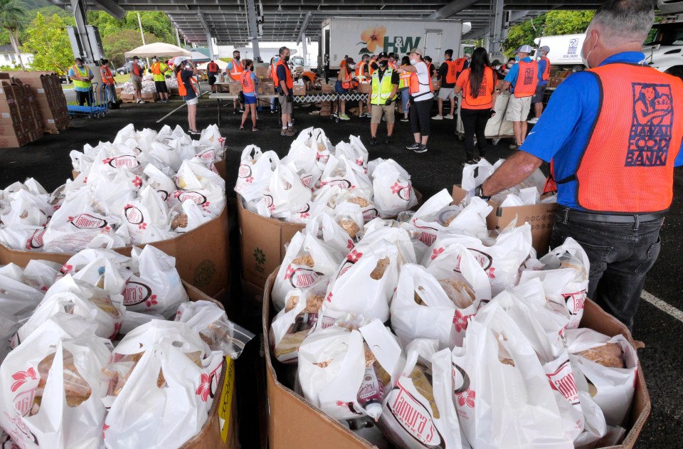 Volunteers assemble food boxes for a distribution event at Windward Community College on Saturday, July 11, 2020. The event was a collaboration between 14 contractors &amp; developers, The Great Aloha Run, and the Hawaii Foodbank spcecifically designed to serve residents of the Windward side from Kualoa to Waimanalo. (Ronen Zilberman photo Civil Beat)