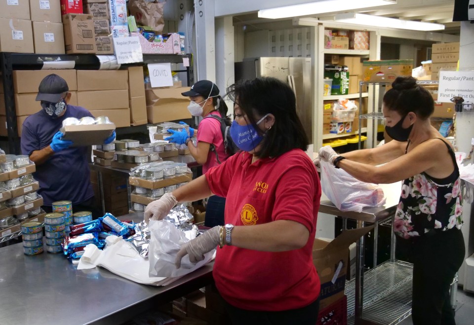 Volunteers from the non-profit Angel Network Charities group prepare bags of dry goods to be given out to those in need, at the Calvary by the Sea Church in Aina Haina, HI, Friday, August 28, 2020. Getting their food donations predominantly through the Foodbank and Aloha Harvest they are currently giving out 28,000lbs of food and serving 1000-1200 families weekly. (Ronen Zilberman photo Civil Beat)