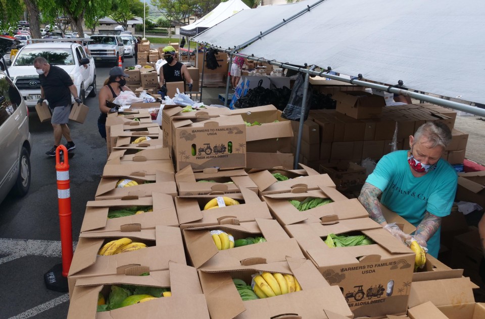 Volunteers for the Hawai’i Health &amp; Harm Reduction Center (H3RC) and the Hawai’i Foodbank work together to pack boxes and load into cars during a free food distribution event at the Windward mall in Kaneohe, HI, Tuesday, Sept. 8, 2020. (Ronen Zilberman photo Civil Beat)