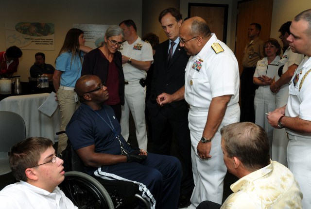 Vice Adm. Adam M. Robinson Jr., Surgeon General of the Navy and Chief of the Navy Bureau of Medicine and Surgery speaks with a wounded warrior at the Lakeshore Foundation in Birmingham, Ala. Lakeshore Foundation recently began a wounded warrior transitioning program called Lima Foxtrot. This event is one of many events held in conjunction with Birmingham Navy Week. Navy Weeks are designed to show Americans the investment they have made in their Navy and increase awareness in cities that do not have a significant Navy presence.