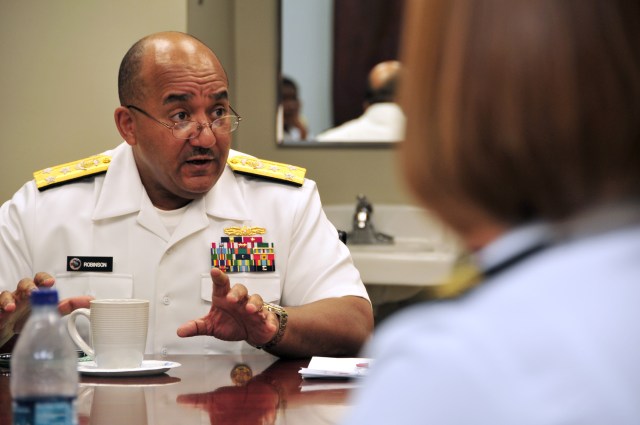 Vice Adm. Adam M. Robinson Jr., Surgeon General of the Navy and Marine Corps and Chief of the Navy Bureau of Medicine and Surgery, speaks with Naval Construction Battalion Center, Gulfport Branch Medical Clinic's leadership as part of a Gulf Coast regional tour of various Navy medical facilities. The surgeon general is on a fact-finding tour gathering feedback about local Navy medicine issues and its support to force readiness.