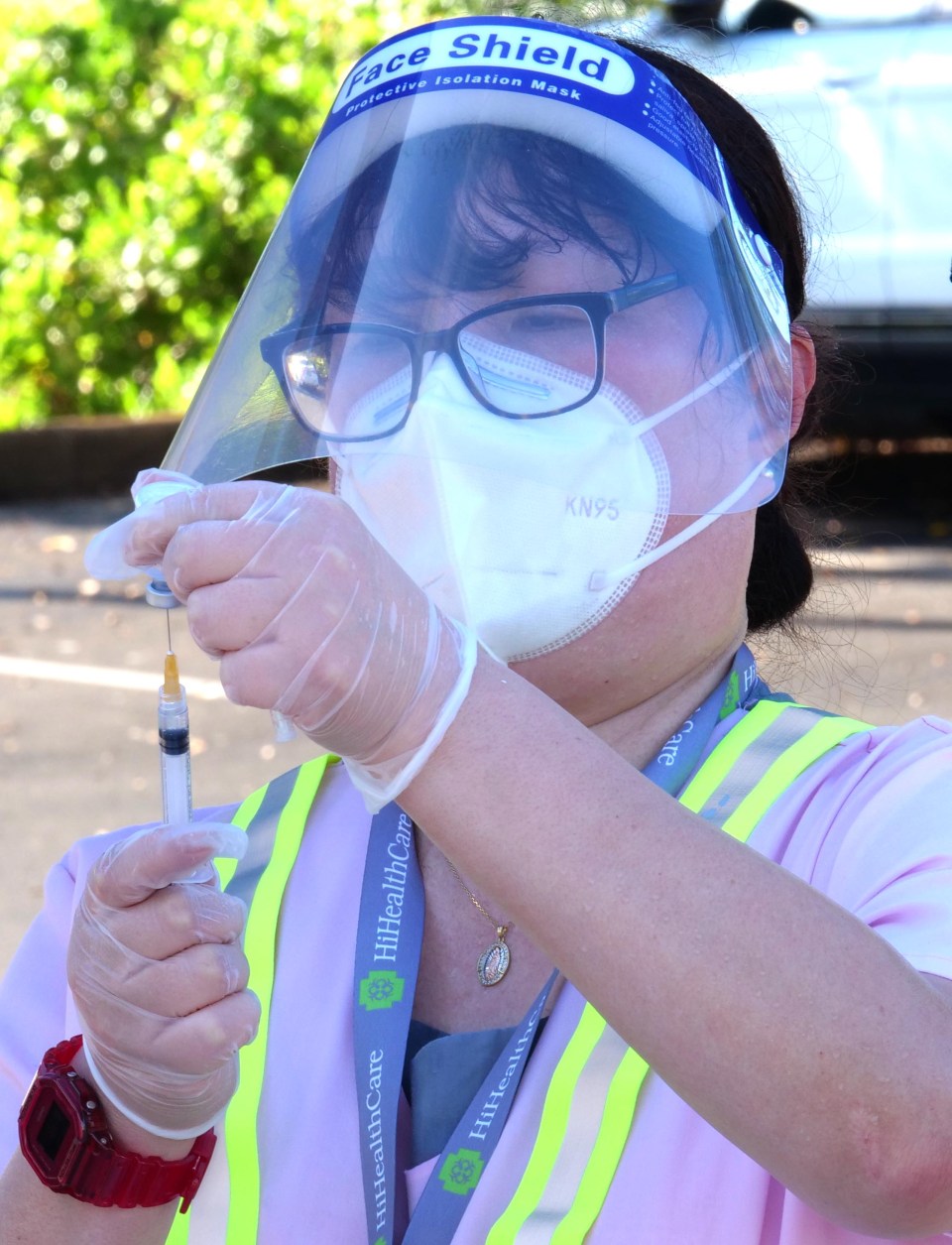 A volunteer prepares flu shots to be administered during a free drive-thru flu shot clinic at the Kaka'ako district park Saturday, Oct. 3, 2020. (Ronen Zilberman photo Civil Beat)