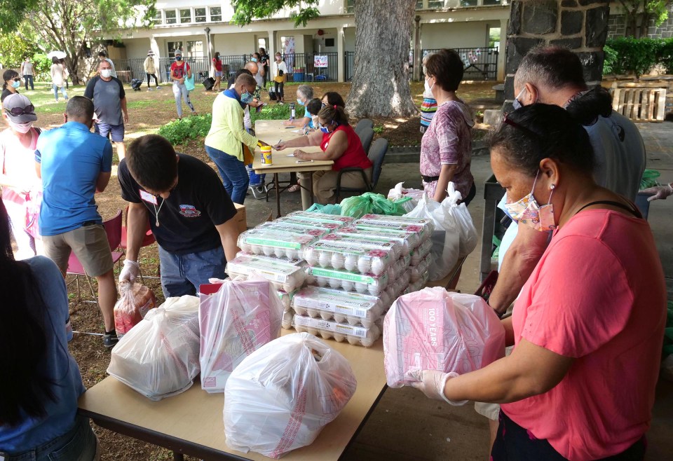 Volunteers bag food donations as people sign-up to receive the packages of food during a distribution event hosted by the Central Union Church in Honolulu, on Wednesday, November 11, 2020. (Ronen Zilberman photo Civil Beat)