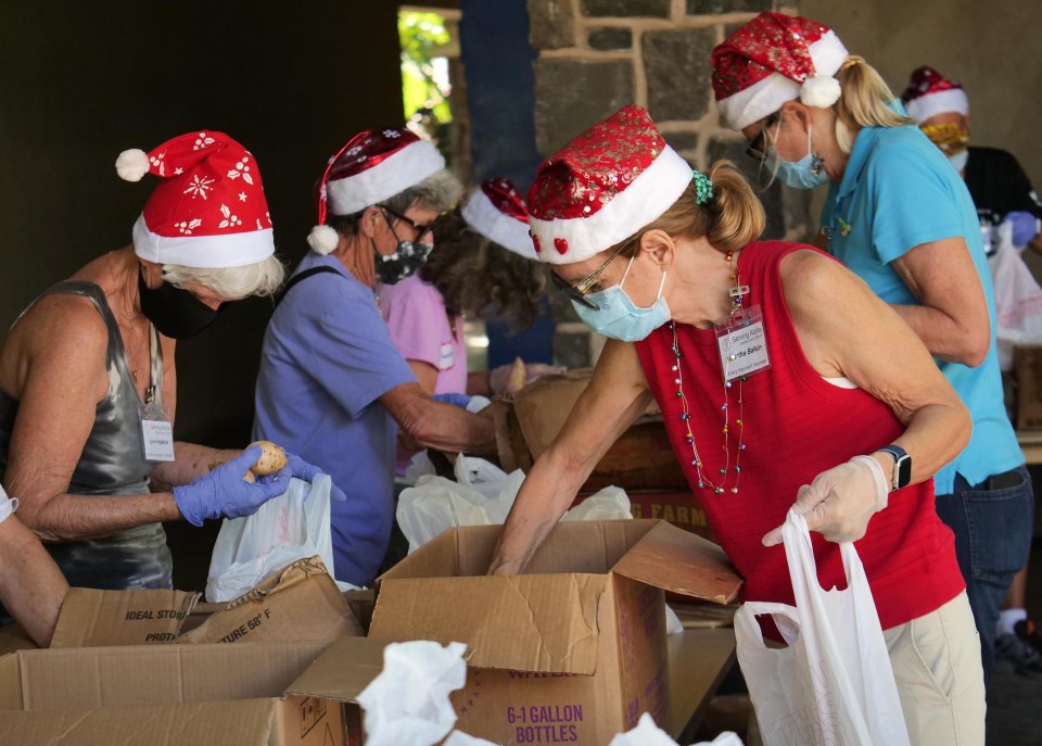 Volunteers dressed in the spirit of Christmas prepare for a food drive at the Central Union Church in Honolulu. Wednesday, December 23, 2020 (Photo: Ronen Zilberman/Civil Beat).