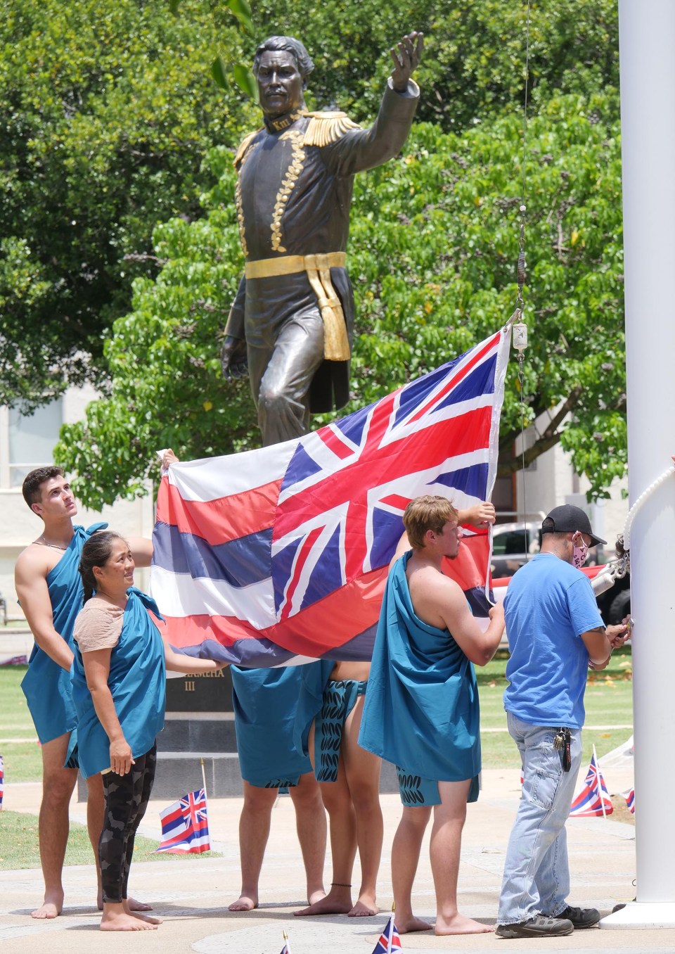 Hawaiian flag being raised at Thomas Square Park in Honolulu on July 31, 2021. At the start of the "Lā Hoʻihoʻi Ea Honolulu" also known as Hawaiian Restoration Day. Comemmorating the return of the Hawaiian Kingdom's Sovereignty from Britain 178 years ago. Photo/Ronen Zilberman Civil Beat