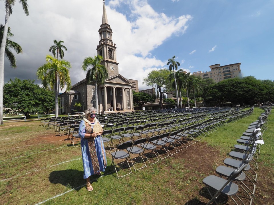 Lauren Buck Medeiros, Chaplain at Punahou School, walks amonst 916 chairs set-up on the lawn of the Central Union Church, as they ring the bells in memory of COVID-19 victims, in Honolulu Monday, November 1, 2021. The chairs represent those who have died from the COVID-19 virus in Hawaii up until this point and each one bears the date that a corresponding life was lost. (Ronen Zilberman photo Civil Beat)
