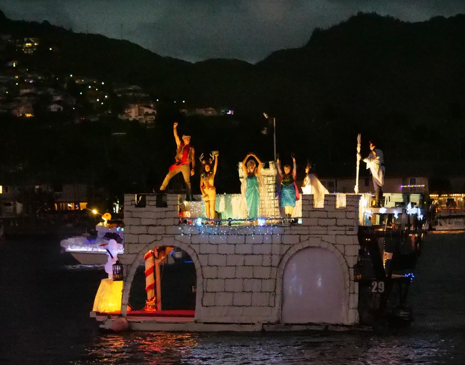 Participants in Hawaii Kai's Festival of Lights parade around the marina in decorated boats to celebrate the holiday season with neighbors and community members onlooking from shore Saturday, December 11, 2021. (Ronen Zilberman photo Civil Beat)
