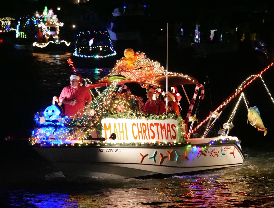 Participants in Hawaii Kai's Festival of Lights parade around the marina in decorated boats to celebrate the holiday season with neighbors and community members onlooking from shore Saturday, December 11, 2021. (Ronen Zilberman photo Civil Beat)