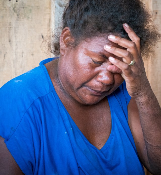 Loretta Manele wipes tears from her face