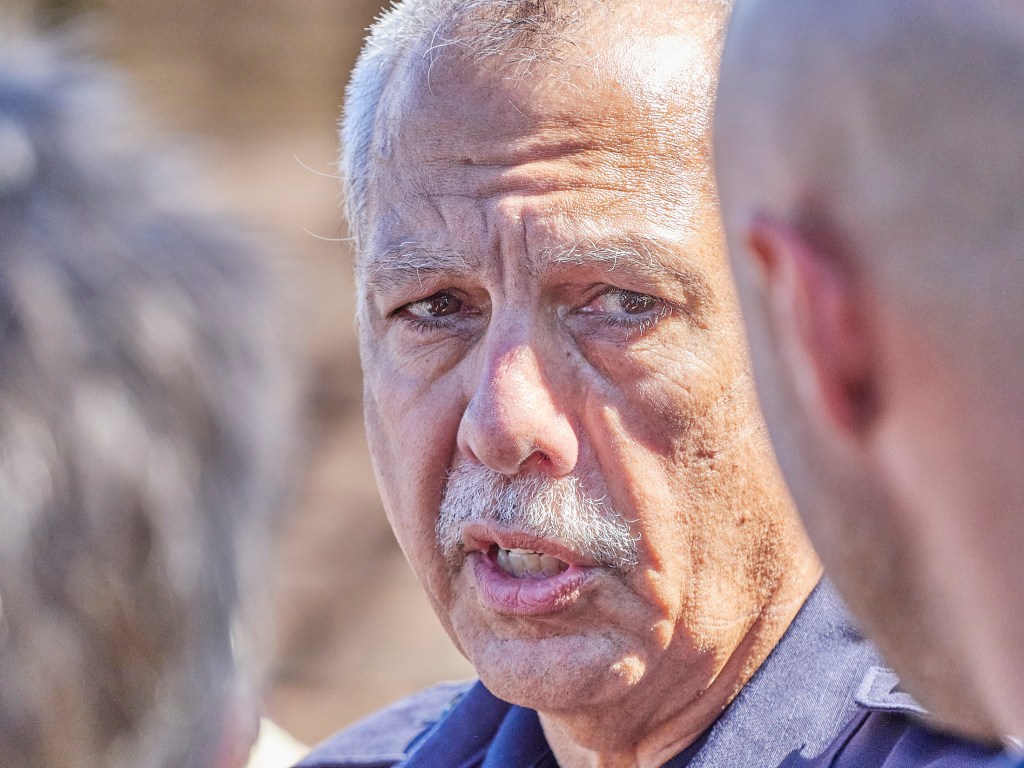 In late September, the county began issuing passes to allow residents to reenter the burn zone. Darryl Oliveira, the interim administrator for the Maui Emergency Management Agency, helped direct residents who were allowed to briefly return to their properties on Kaniau Road. (David Croxford/Civil Beat/2023)