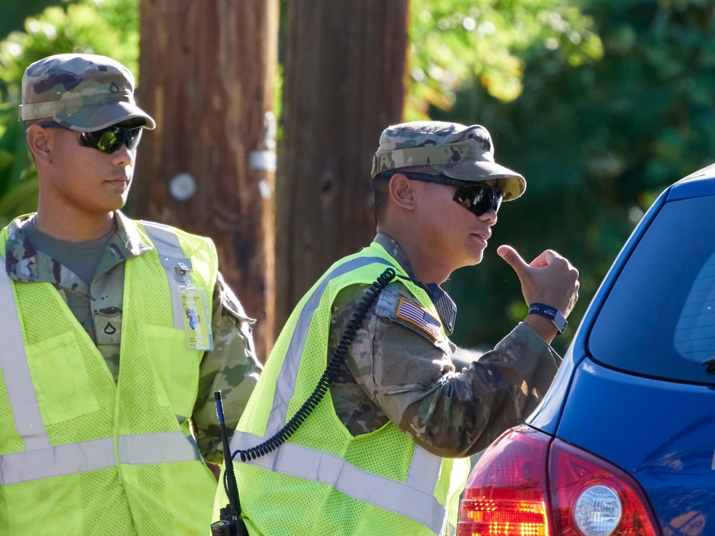 The reopening of a section of Lahaina for families to survey the remains of their homes along Kaniau Road marked a turning point in Lahaina’s slow recovery. National Guardsmen manned a security entrance to the area and volunteers dressed in protective coveralls offered emotional support or help searching through the ash for keepsakes. (David Croxford/Civil Beat/2023)