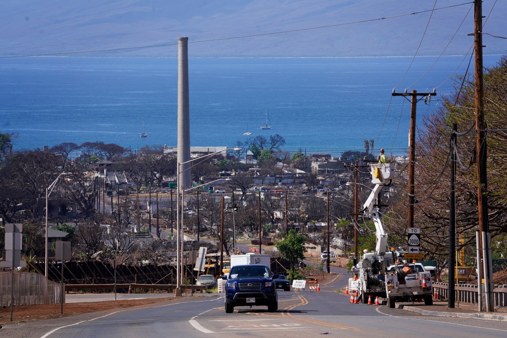 HECO works on a utility line Thursday, Nov. 9, 2023, on Lahainaluna Road in Lahaina. Lahaina town was devastated by the Aug. 8. fire. Tourism reopened in West Maui on Nov. 1. (Kevin Fujii/Civil Beat/2023)