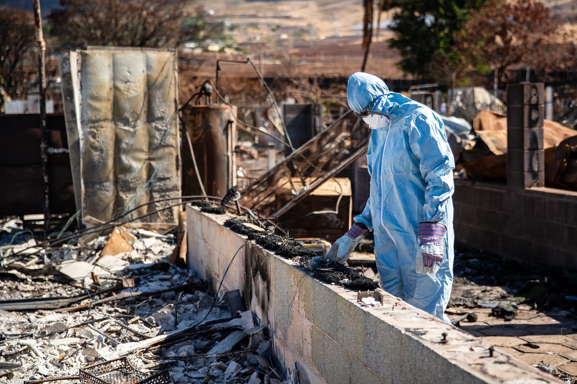 Andreza Cicchino sifts through some of the items she pulled from the ashes of her home during her first return to the property since the Aug. 8 fires. (Nathan Eagle/Civil Beat/2023)