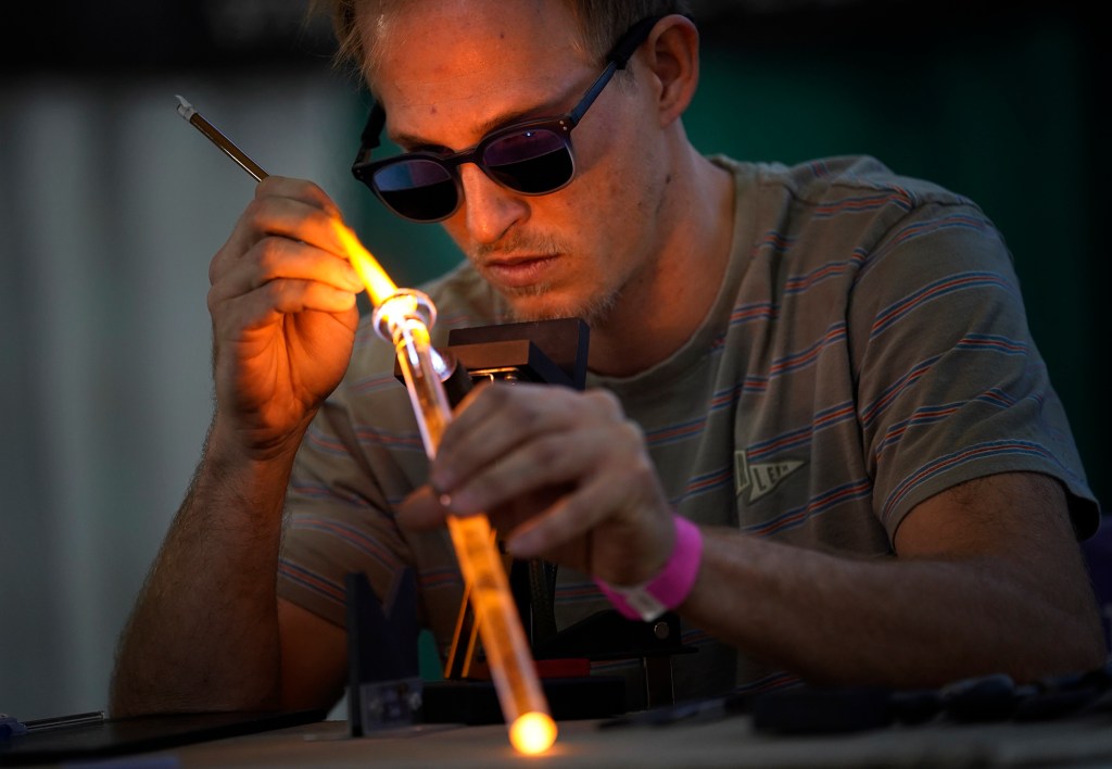 Mike Magnussen of Oahu Glass creates a decorative marble during the Hawaii Cannabis Expo Friday, Feb. 2, 2024, at the Blaisdell Exhibition Hall in Honolulu. More than cannabis, vendors showed off other naturally occurring medicines and associated merchandise. (Kevin Fujii/Civil Beat/2024)