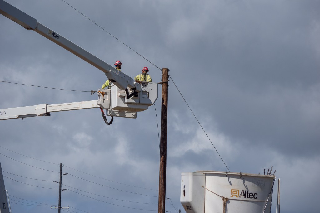 Workers replacing power lines along the Cane Road Makai of Kuhua Street in Lahaina Maui, photographed Tuesday March 5th, 2024. (David Croxford/Civil Beat/2024)