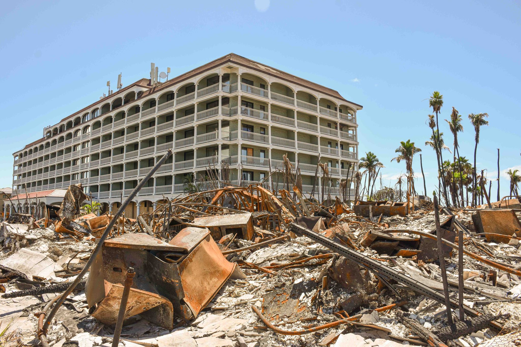 One of the trickiest commercial buildings to clear of fire debris is 505 Front St., which includes a flooded underground garage and is next to a surviving building, Lahaina Shores Beach Resort. (Cammy Clark/Civil Beat/2024)