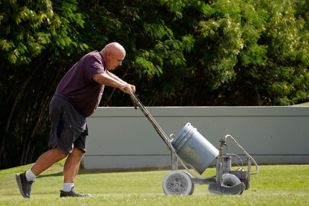 Danny’s Airless Equipment owner Rich Wentling lines the mauka penalty box at the Waipio Peninsula Soccer Stadium field Wednesday, Sept. 18, 2024, in Waipahu. The Rainbow Wahine hosts UC Davis Thursday. This is the University of Hawaii women soccer team’s home field. (Kevin Fujii/Civil Beat/2024)