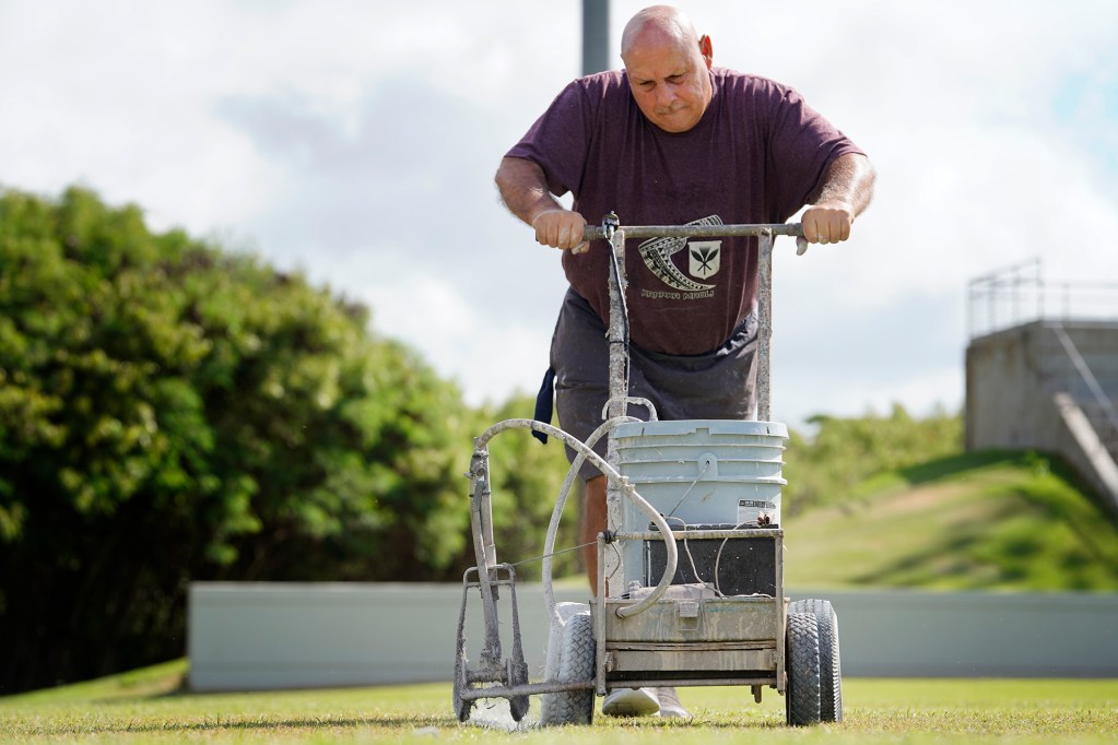 Danny’s Airless Equipment owner Rich Wentling lines the mauka penalty box at the Waipio Peninsula Soccer Stadium field Wednesday, Sept. 18, 2024, in Waipahu. The Rainbow Wahine hosts UC Davis Thursday. This is the University of Hawaii women soccer team’s home field. (Kevin Fujii/Civil Beat/2024)