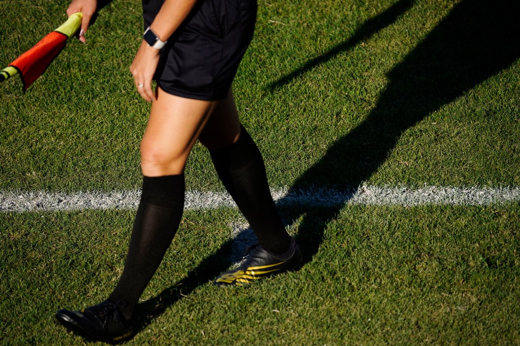 An assistant referee walks down the Ewa touchline before the second half of the University of Hawaii Wahine and Hawaii Pacific University soccer match Sunday, Sept. 22, 2024, at the Waipio Peninsula Soccer Stadium field in Waipahu. The touchline is the longest dimension of a soccer pitch measuring 120 yards. (Kevin Fujii/Civil Beat/2024)