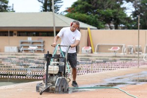 Jhonathan Gonzalez Soto, of Red Lightning, recuts the drainage lines at Lahaina Aquatic Center. (courtesy: Red Lightning)