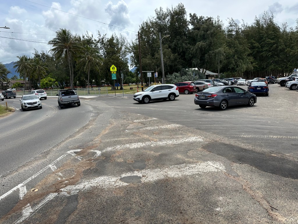 The parking entrance to Kailua Beach park at the Lanikai boat ramp and the obliterated cross walk.