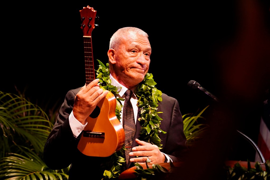 Maui Mayor Richard Bissen gives the crowd a look after pulling out his ukulele to lead “Hawai’i Aloha” after giving the state of the county address Friday, March 7, 2025, in Kahului. (Kevin Fujii/Civil Beat/2025)