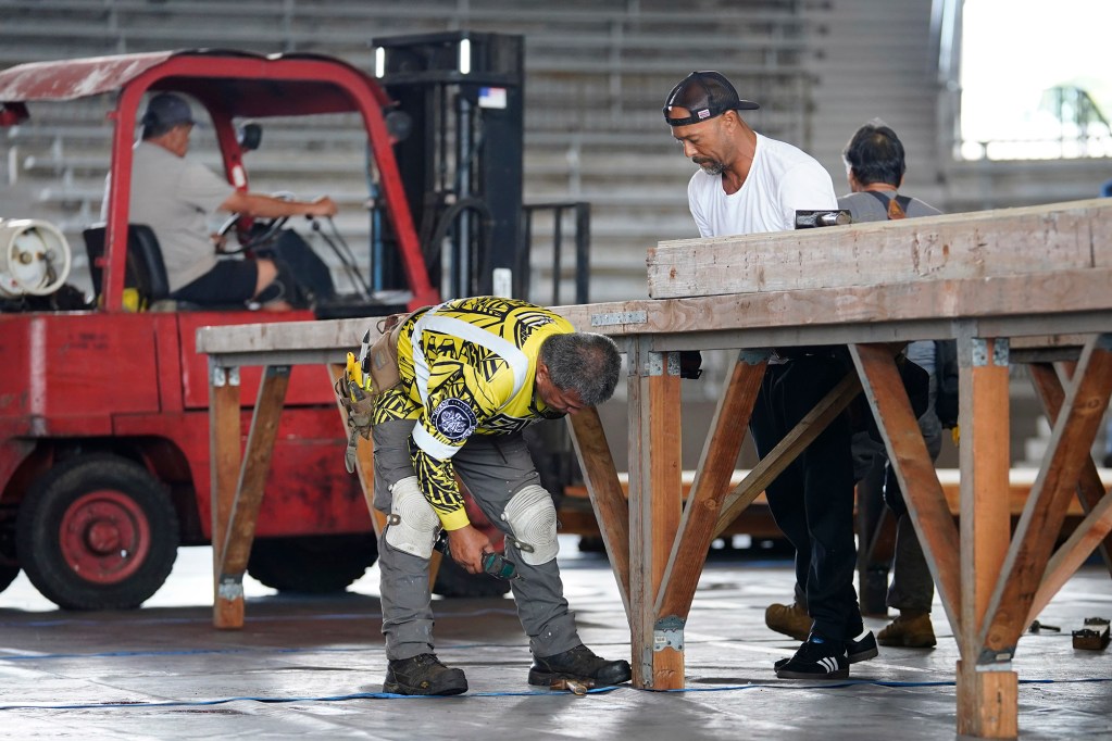 Carpenters assemble the stage for the 62nd Annual Merrie Monarch Festival Monday, March 10, 2025, in Hilo's Edith Kanakaole Multi-Purpose Stadium. It will take a week to construct the stage and auxiliary structures. The marquee hula festival runs April 20-26. (Kevin Fujii/Civil Beat/2025)
