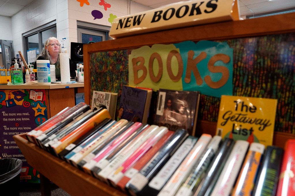 The New Books display blocks a Waiākae High School student talking story with librarian Leslie Fukushima Monday, March 10, 2025, in Hilo. (Kevin Fujii/Civil Beat/2025)