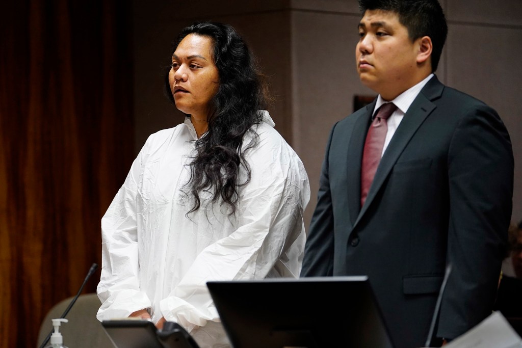Sina Pili, 39, left, stands with public defender Samson Shigetomi during her arraignment on manslaughter charges Thursday, March 13, 2025, in Honolulu. Her adopted daughter Azaeliyah Pili-Ah died Dec. 22, 2023. Emergency services found Azaeliyah unresponsive with bruises on her body and face in Pili’s Lā’ia home. Pili worked as a Department of Education behavioral health specialist since 2015. (Kevin Fujii/Civil Beat/2025)