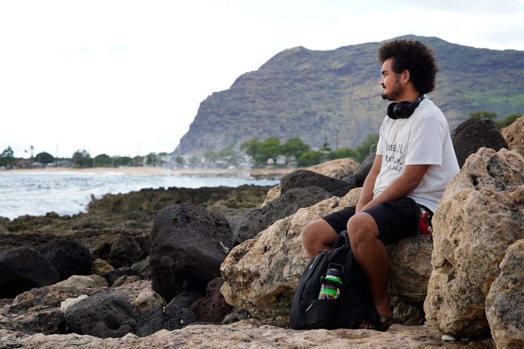 Aden Campbell-McAngus is photographed along the Wai’anae Coast Tuesday, March 25, 2025, behind Wai’anae High School in Wai’anae. Aden spent time on the streets as a homeless youth. But he’s currently living in Mililani and attending college classes in Wai’anae. (Kevin Fujii/Civil Beat/2025)