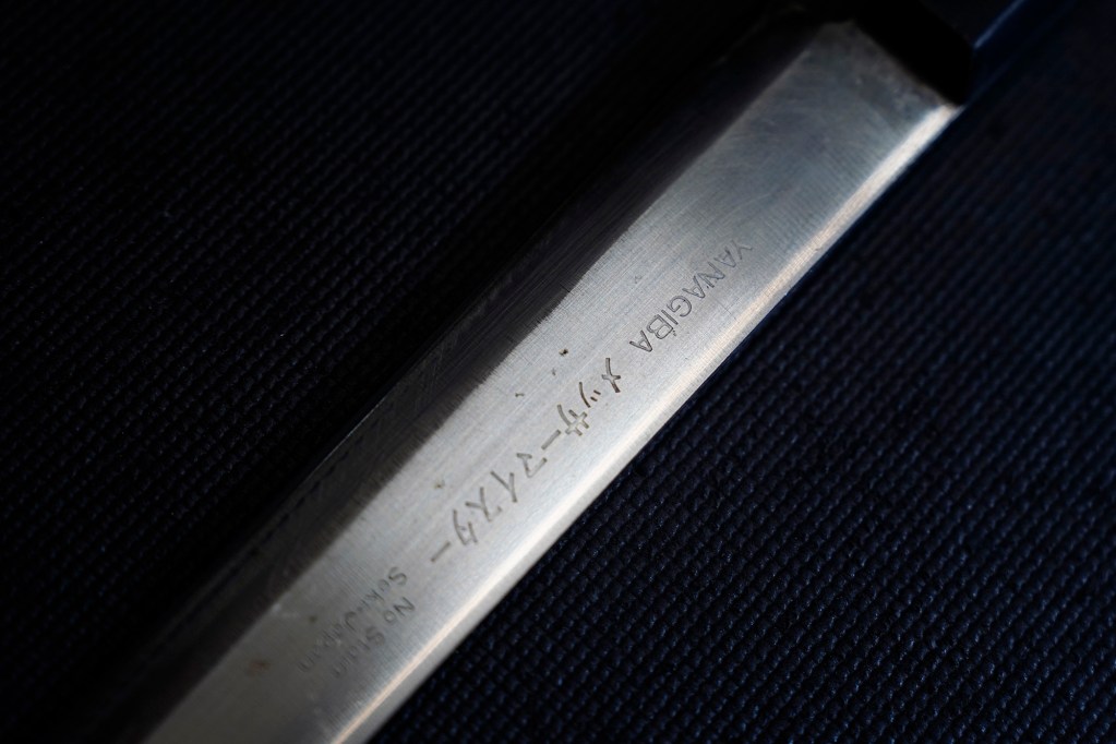 A Japanese Yanagiba knife is sharpened and ready for its chef to slice sashimi after Blade Works 808’s Jeff Bonisa worked on it Wednesday, Aug. 25, 2025, in Kahuku. Bonisa goes where his customers are or can be found at farmers markets. (Kevin Fujii/Civil Beat/2025)