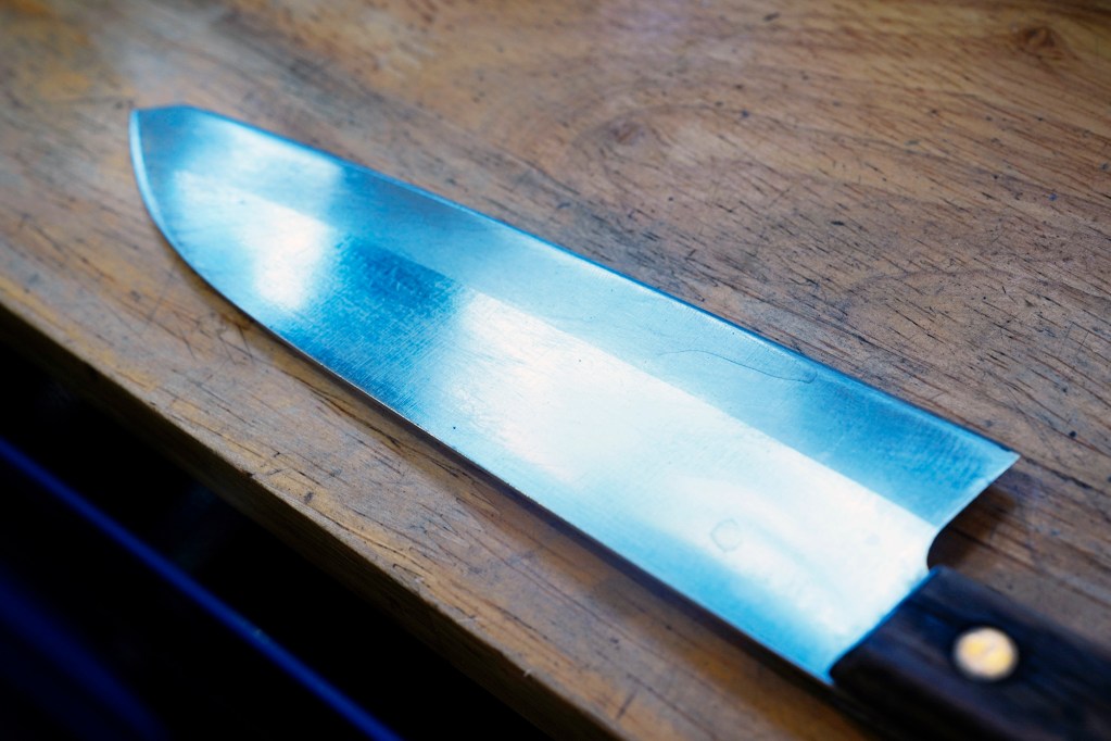 Blade Works 808’s Jeff Bonisa gets a family favorite knife to repair and sharpen Wednesday, Aug. 25, 2025, in Kahuku. This knife is approximately 60-years-old with a broken tip. (Kevin Fujii/Civil Beat/2025)