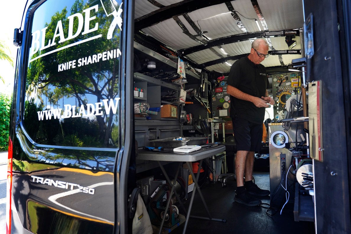 Blade Works 808’s Jeff Bonisa works out of his utility van to sharpens knives for a restaurant Wednesday, Aug. 25, 2025, in Kahuku. Bonisa goes where his customers are or can be found at farmers markets. (Kevin Fujii/Civil Beat/2025)