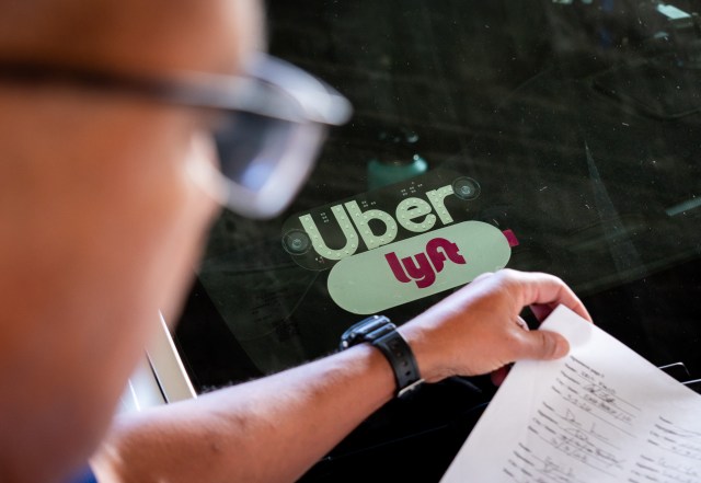 Uber and Lyft stickers on the windshield of a driver's car at the rideshare lot at Daniel K. Inouye International Airport April 20, 2026. (Craig Fujii/Civil Beat/2026)