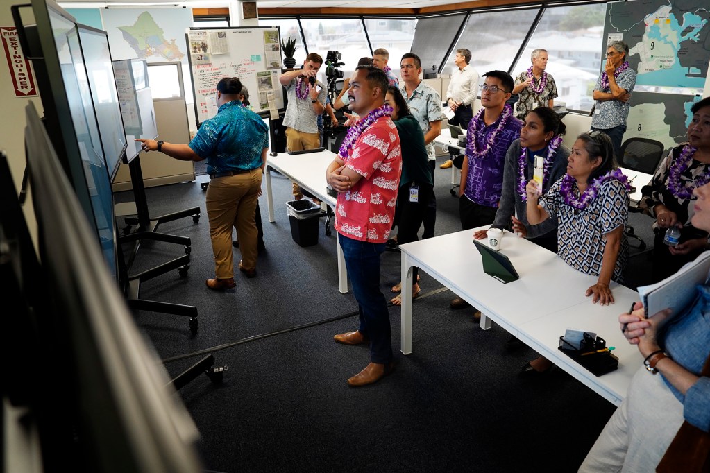 Visitors get a tour of the City and County of Honolulu’s new Department of Community Services (DCS) and Kōkua Command Center on Monday, June 8, 2026, in Honolulu. Data from across Oʻahu will help City and County teams and providers to connect homeless with resources. (Kevin Fujii/Civil Beat/2024)