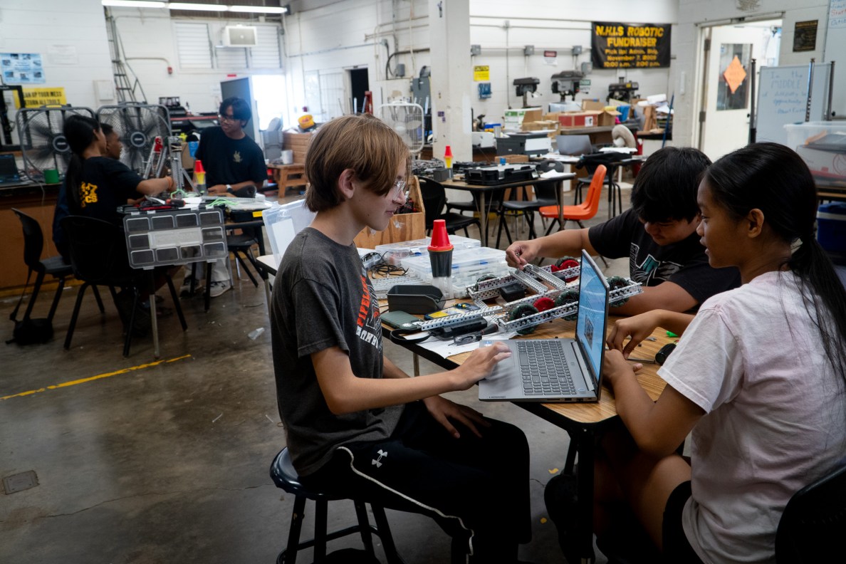 A robotics team at work at Nānākuli High & Intermediate School June 29, 2026. From right, are: Khailey Buentipo, Ethan Faeldonea, and Seiji Nakata. (Craig Fujii/Civil Beat/2026)
