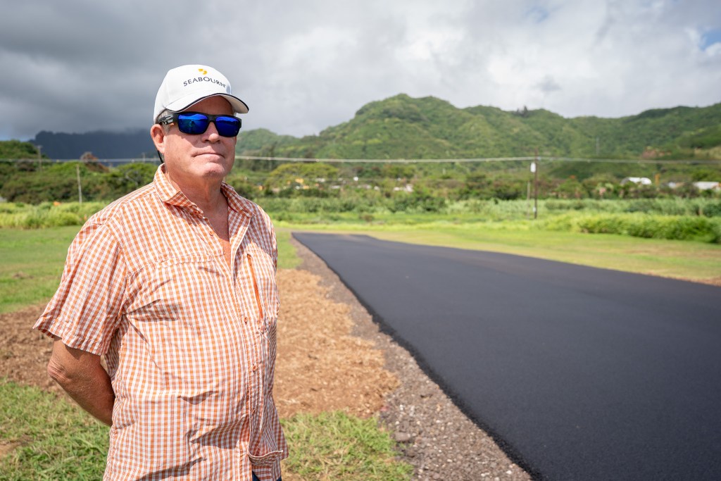 Tom Bellit saw construction at Kawainui Model Airplane Field in Kailua and wondered what was going on. He was photographed by the newly paved runway June 19, 2026. (Craig Fujii/Civil Beat/2026)